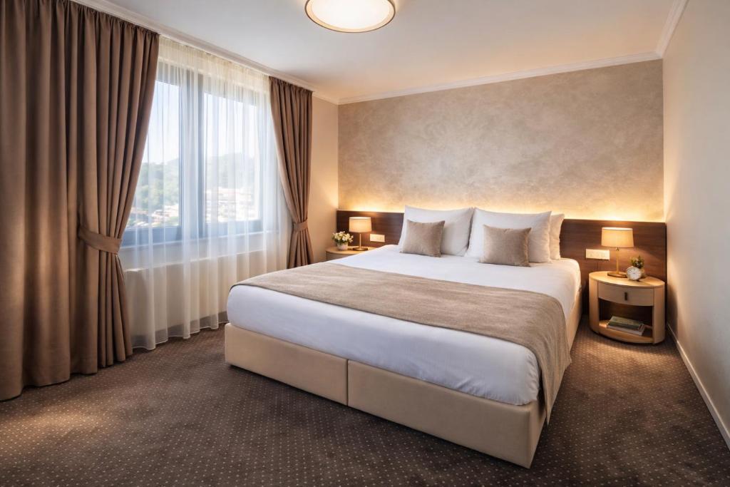 a hotel room with a large bed and a window at Nobel West Hotel in Belgrade