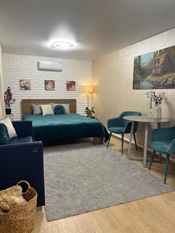 a bedroom with a bed and a table and chairs at Гостьовий будинок для відпочинку в Nesterivka Family Park in Boryspil