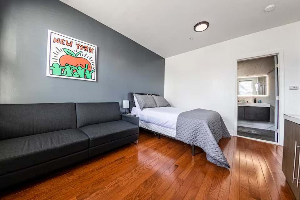 a living room with a couch and a bed at Shefah Hotel in Union City