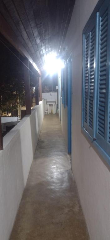 a hallway of a building with a light on it at Casas oliveira in Paraty
