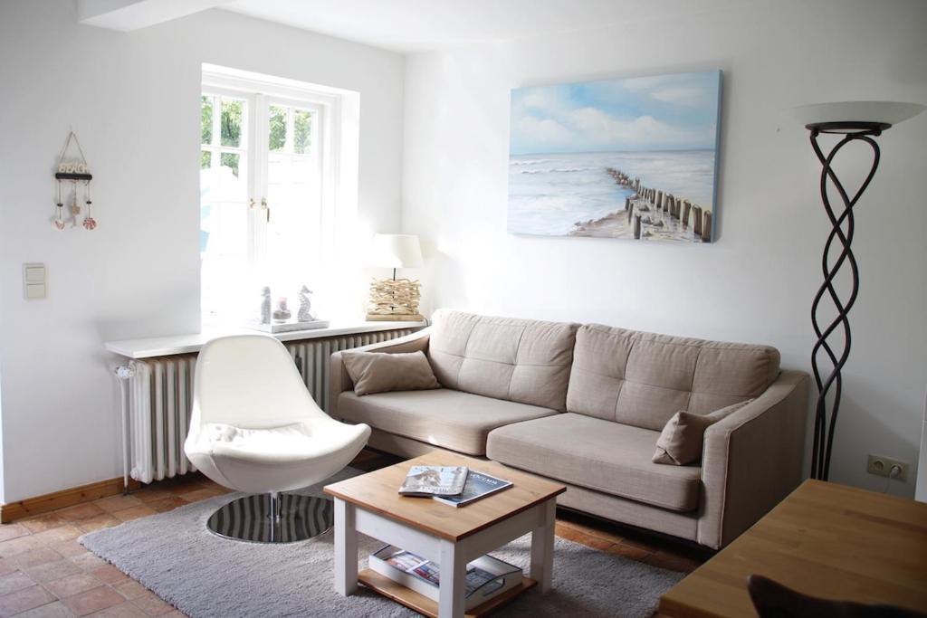 a living room with a couch and a table at Stutenhof-Wohnung-06 in Keitum