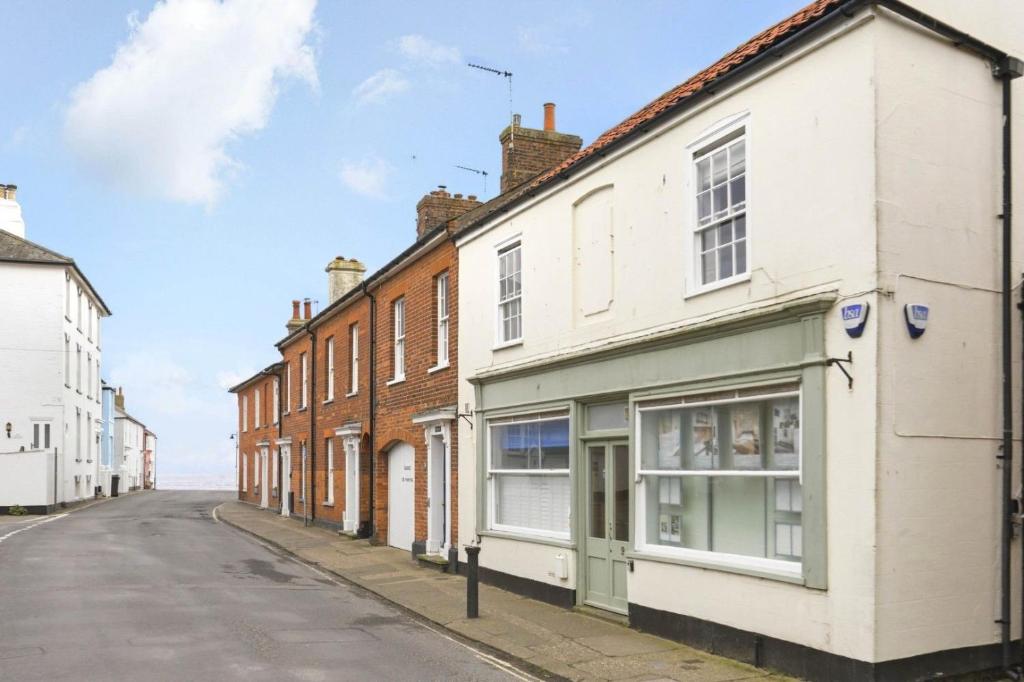 a row of houses on an empty street at Shiny Pebble in Southwold