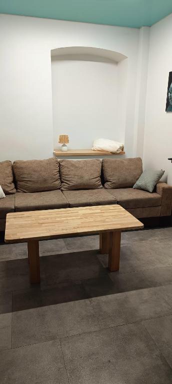 a living room with a couch and a wooden coffee table at Apartament u Piotrusia i Paulinki in Stronie Śląskie