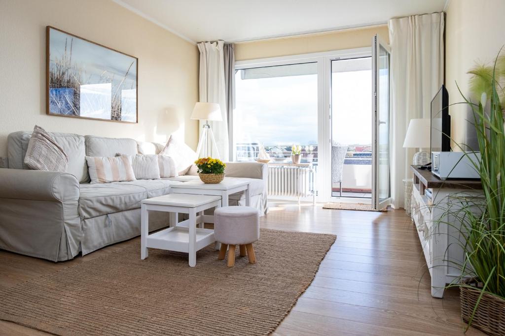 a living room with a couch and a table at Norderhoog-Whg-45-2-OG-O-Wohnung-45 in Westerland