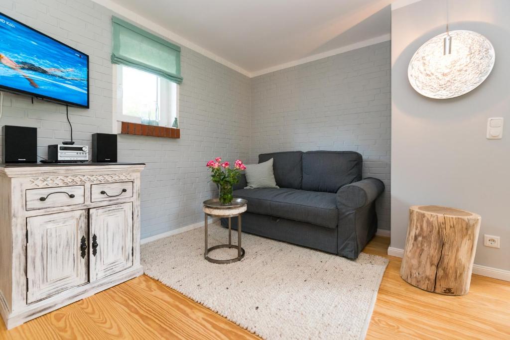 a living room with a couch and a tv at Bandomir-Bungalow-Wohnung-02 in Westerland