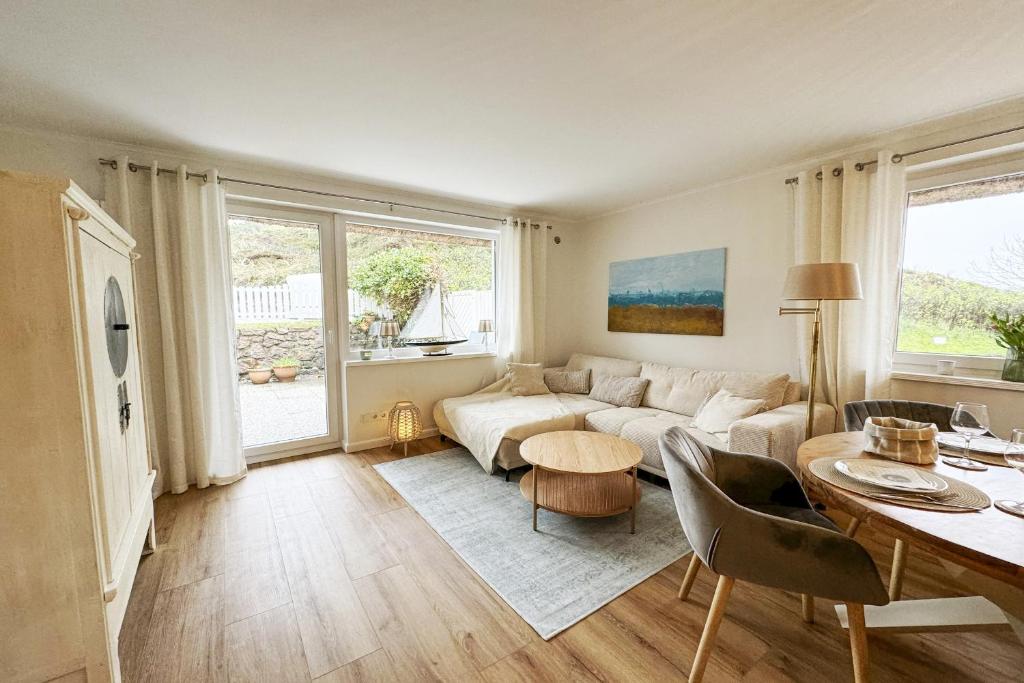 a living room with a couch and a table at Haus-Excelsior-Wohnung-08 in Rantum