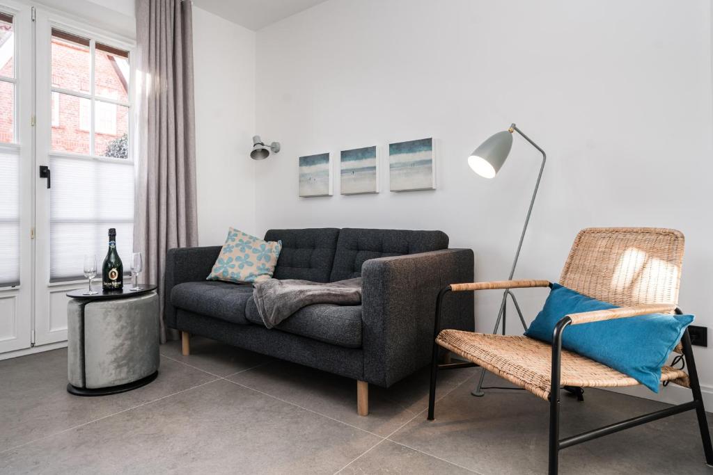 a living room with a couch and a chair at Haus-Friesenperle in Westerland