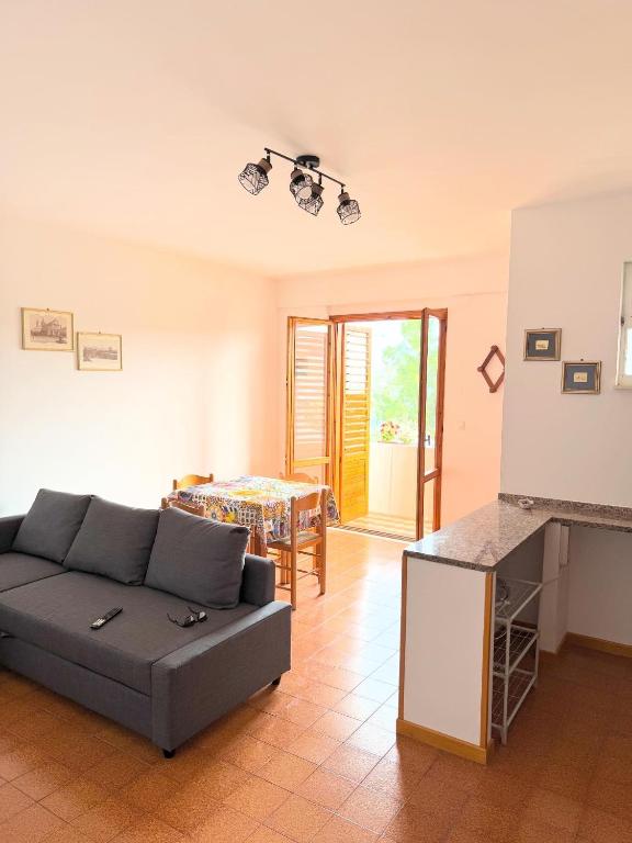 a living room with a couch and a table at A montagna e u mari home in Aci Castello