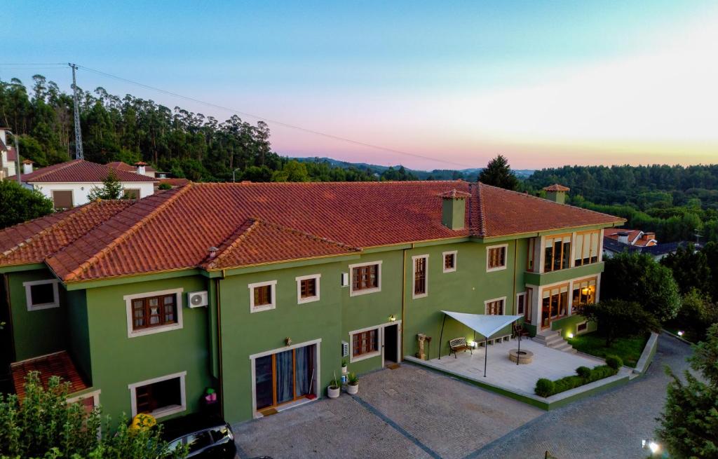 a large green house with a red roof at Villa Maria Caetana in Frazão