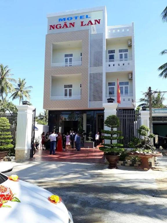 a large building with people standing outside of it at Hotel Ngân Lan in Ga Tam Quan