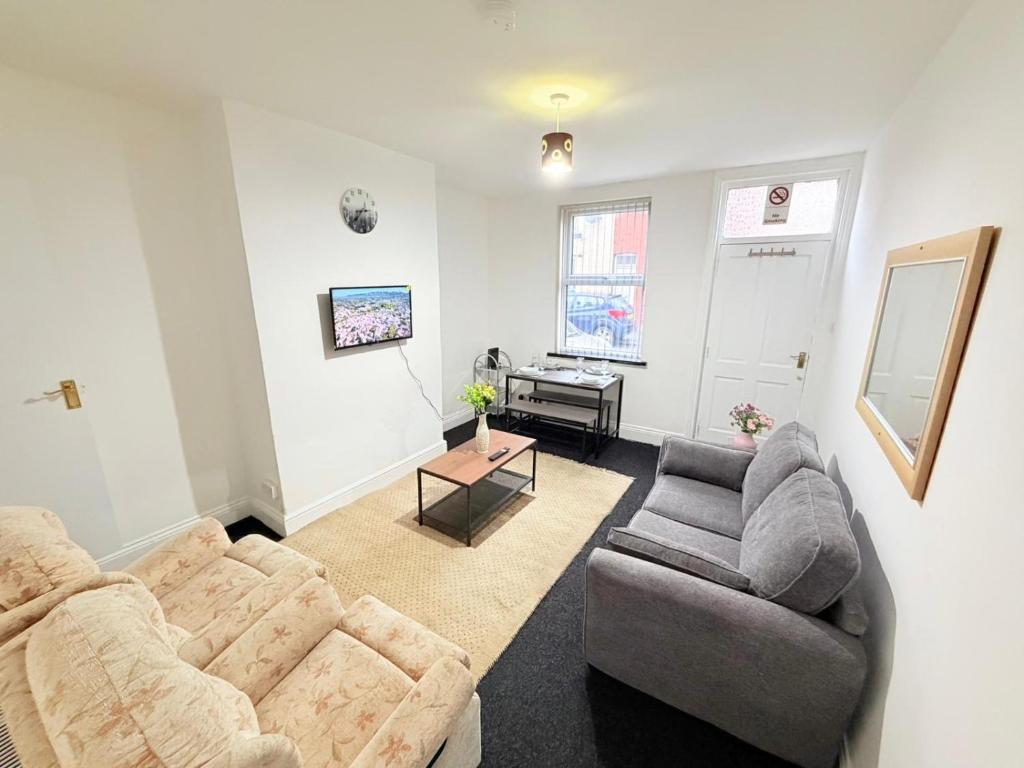 a living room with a couch and a chair at Cozy corner - 3 Bedroom Full House - Perfect for Families, Couples And Company Contractors in Wakefield