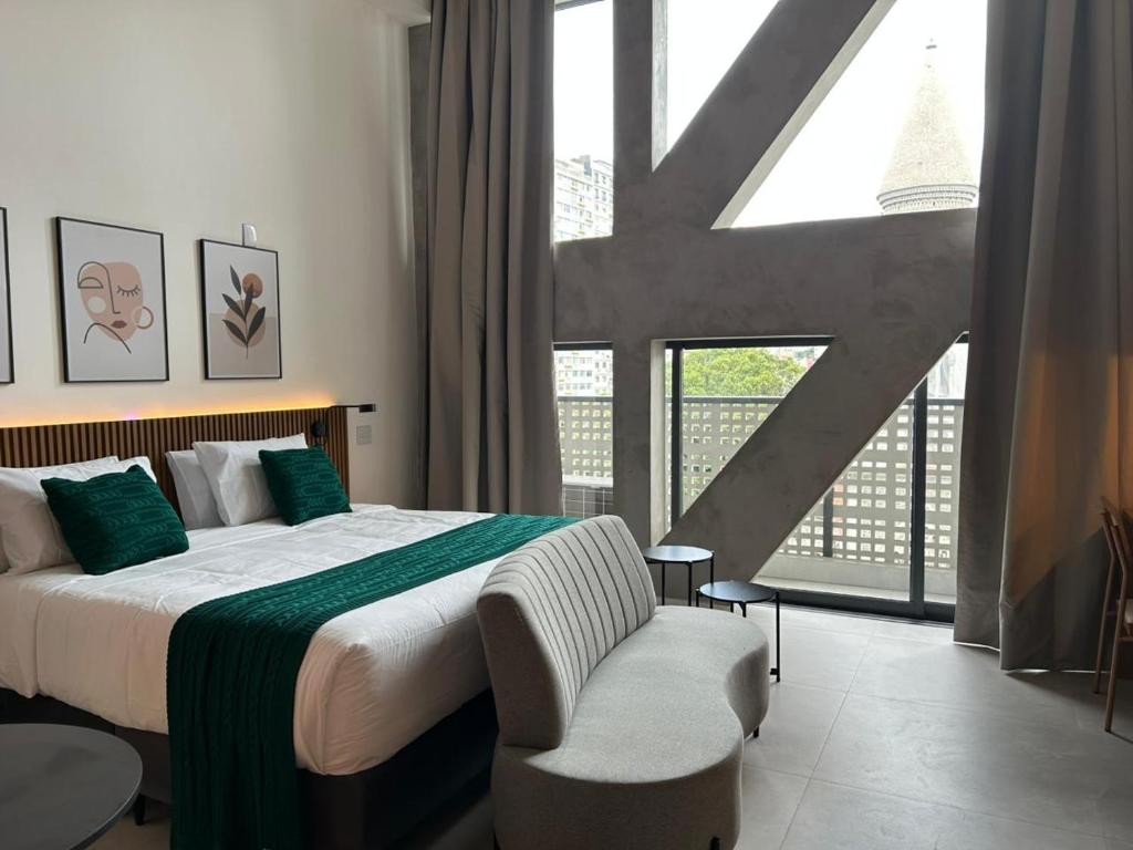 a bedroom with a bed and a large window at Heritage X in São Paulo