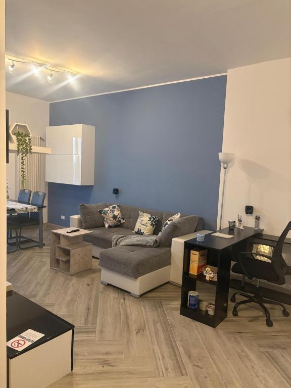 a living room with a couch and a table at Pella House in Airasca