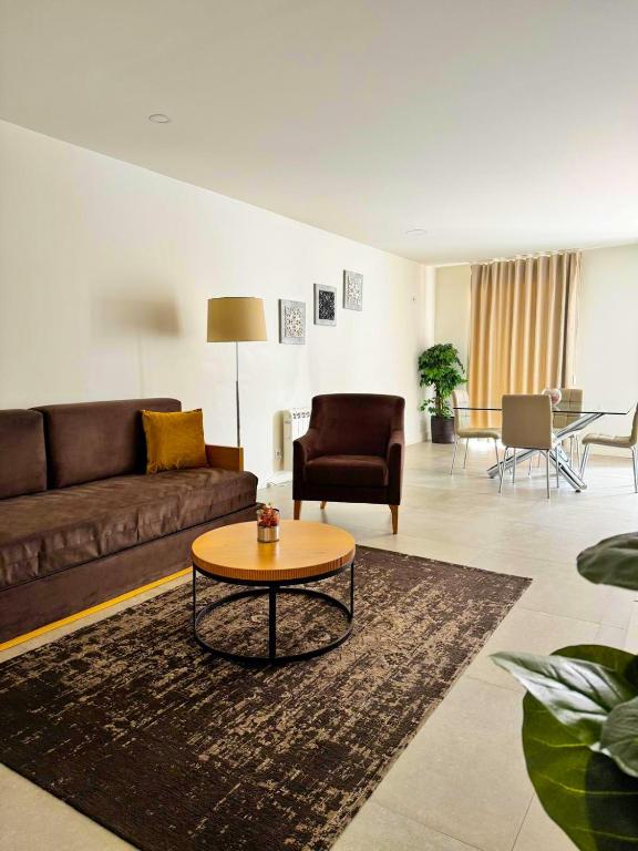 a living room with a couch and a coffee table at Apartamentos Fonte Velha in Ponte da Barca