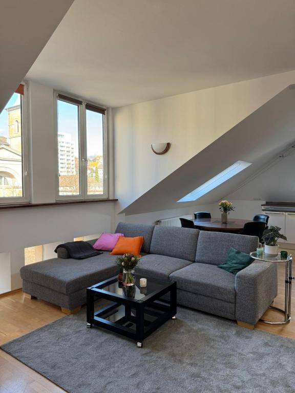 a living room with a couch and a table at Helle Dachgeschoßwohnung am Laurentiusplatz in Wuppertal