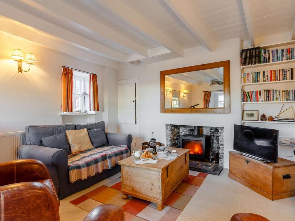 a living room with a couch and a fireplace at 2 Bed in Polruan oc-pc033 in Fowey