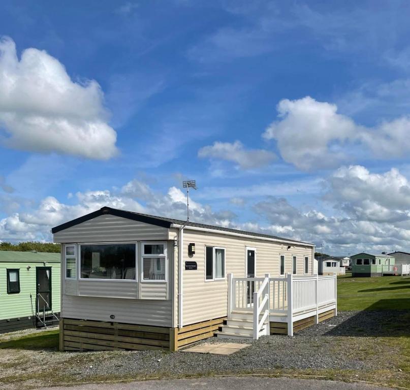 a tiny house is parked in a field at Shellie's Summer Breeze Retreat in Heysham