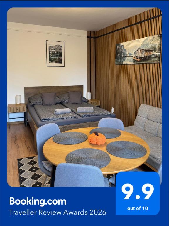 a bedroom with a table and a bed and a couch at Mini Premium in Miskolc