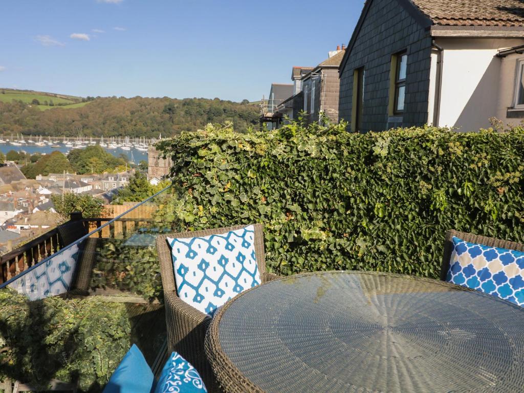 a patio table and chairs with a view of the water at 36 Crowthers Hill in Dartmouth
