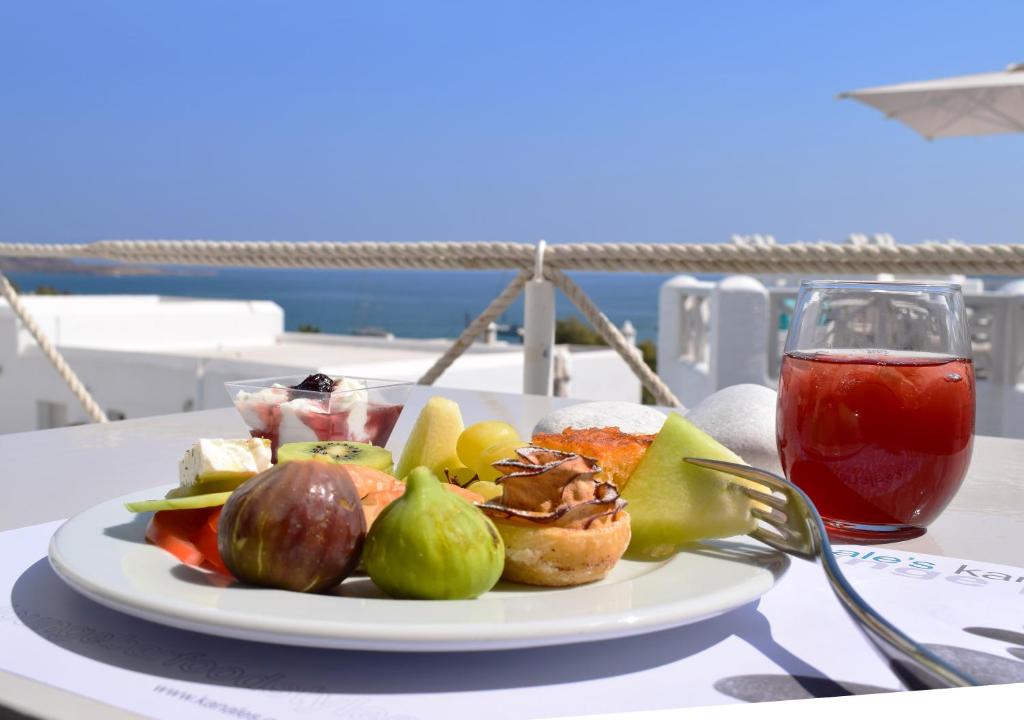 a plate of food on a table with a drink at Kanale's Rooms & Suites in Naousa