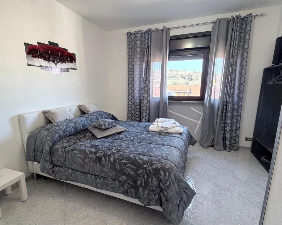 a bedroom with a bed and a window at Casa Baccanico - a due passi da autostazione in Avellino