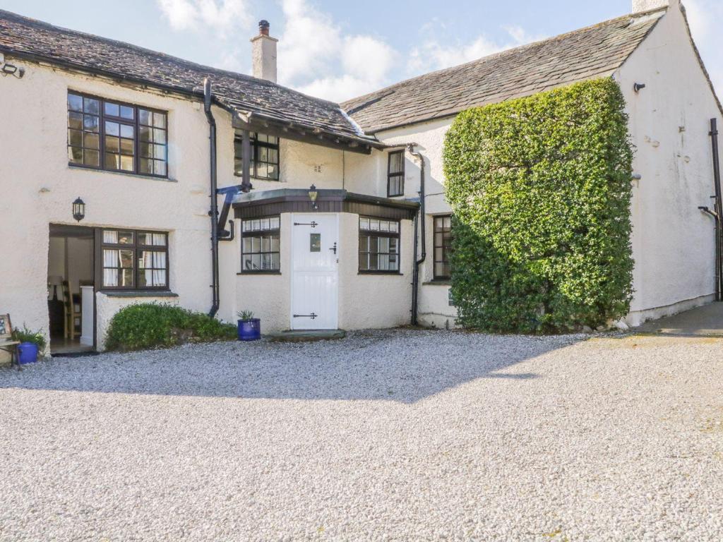 a large white house with a driveway at The Farmhouse in Keswick