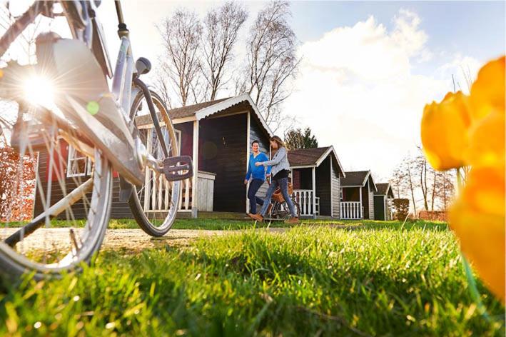 two people walking in front of a house at Dromen bij de boer in Oene