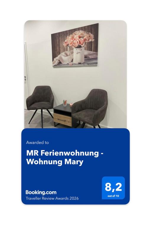 two chairs in a room with a vase of flowers at MR Ferienwohnung - Wohnung Mary in Barsinghausen