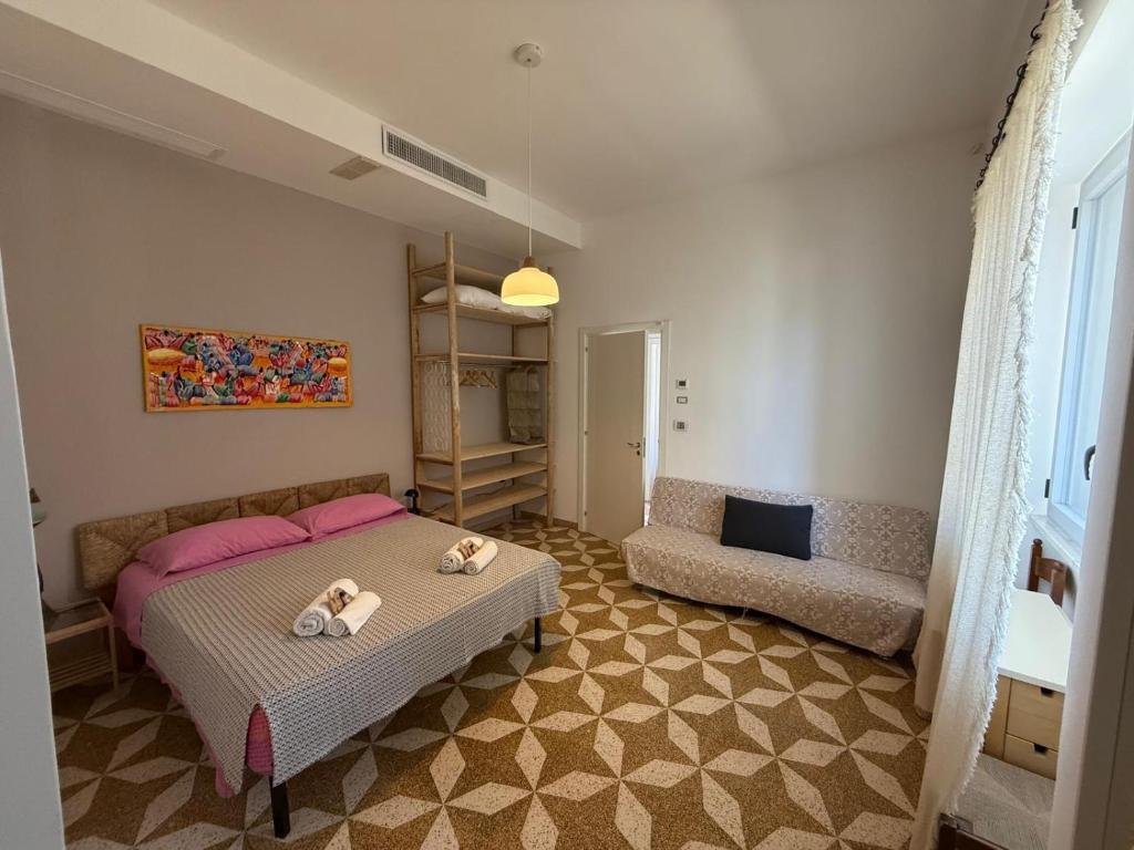 a bedroom with a bed and a couch at casa surano in Diso