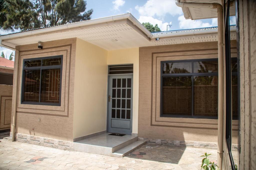 a small house with a blue door at Aiden House Arusha in Arusha