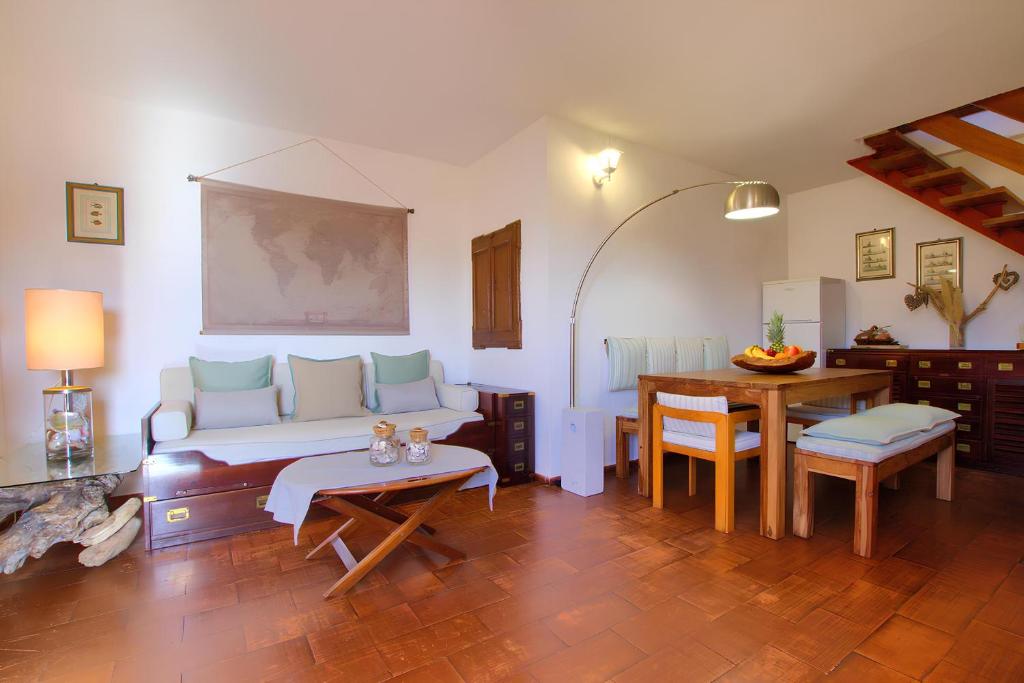 a living room with a couch and a table at 20 passi dalla spiaggia - Panoramic Duplex in Porto Rotondo