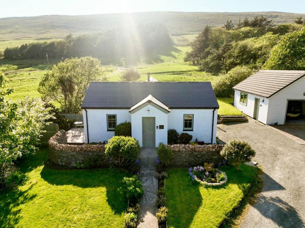 an aerial view of a white house with a garden at Evrabister, Shetland Islands in Mainland