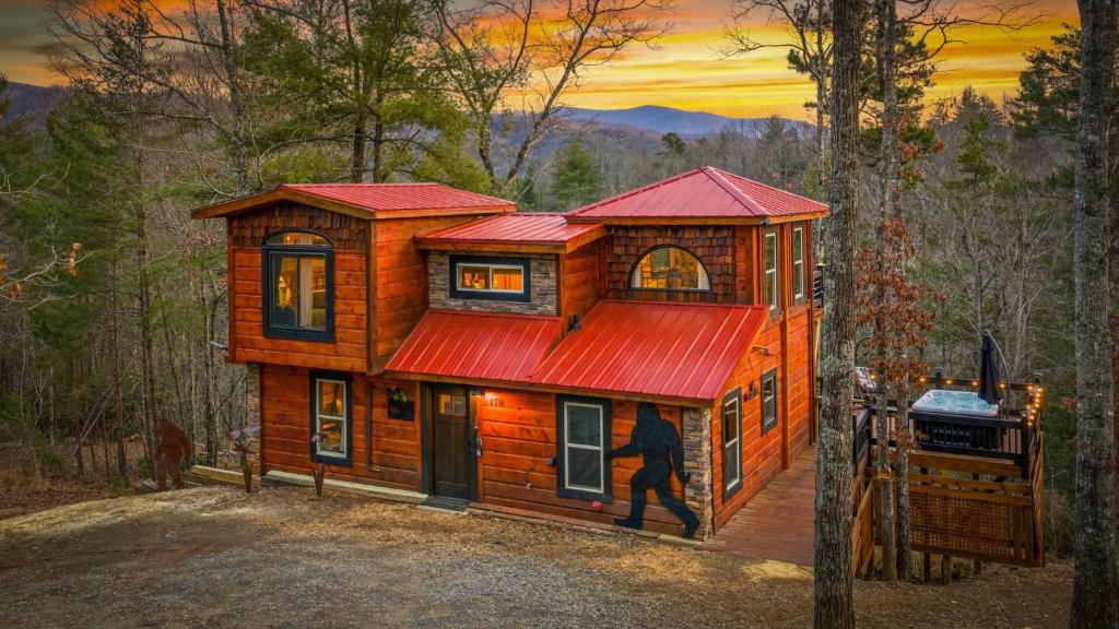 a large wooden house with a red roof at Bigfoot's Hideout in Blue Ridge