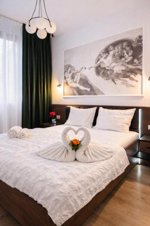 a bedroom with a bed with a flower on it at Sika Jolly Apartment - cazare Arad - self check-in in Arad