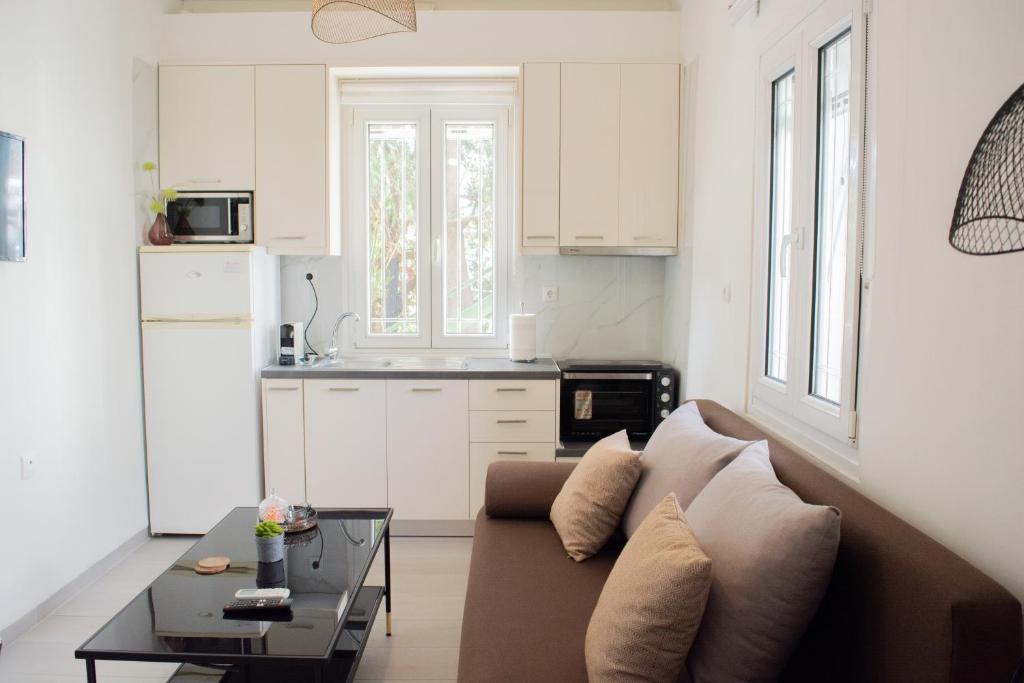 a living room with a couch and a table at Helia Apartment 1 in Alepou