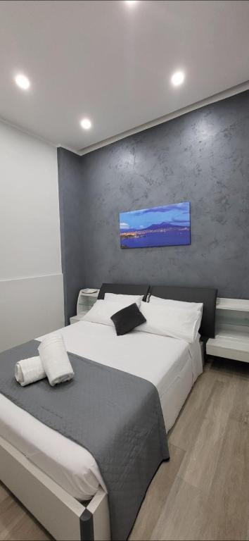 a bedroom with a large bed with a tv on the wall at Renova7io sweet home Napoli in Naples