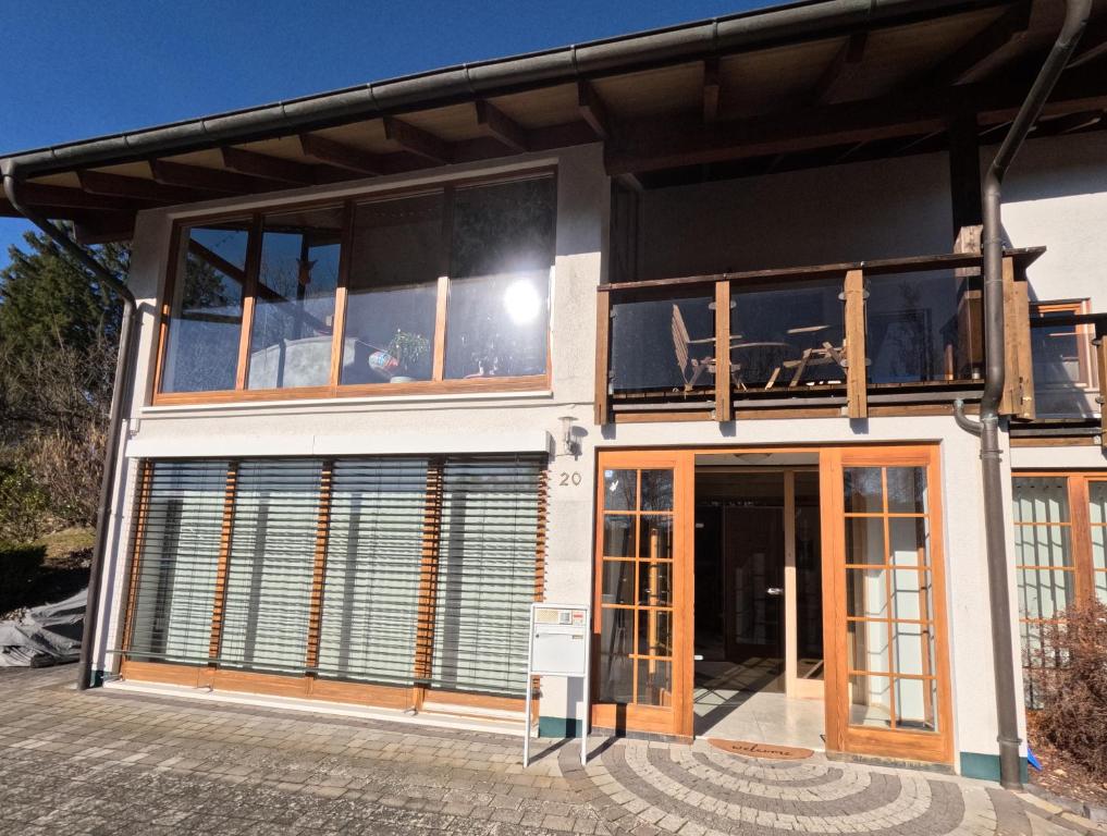 a house with glass doors and a balcony at FeWo zum Der Hilderser in Hilders