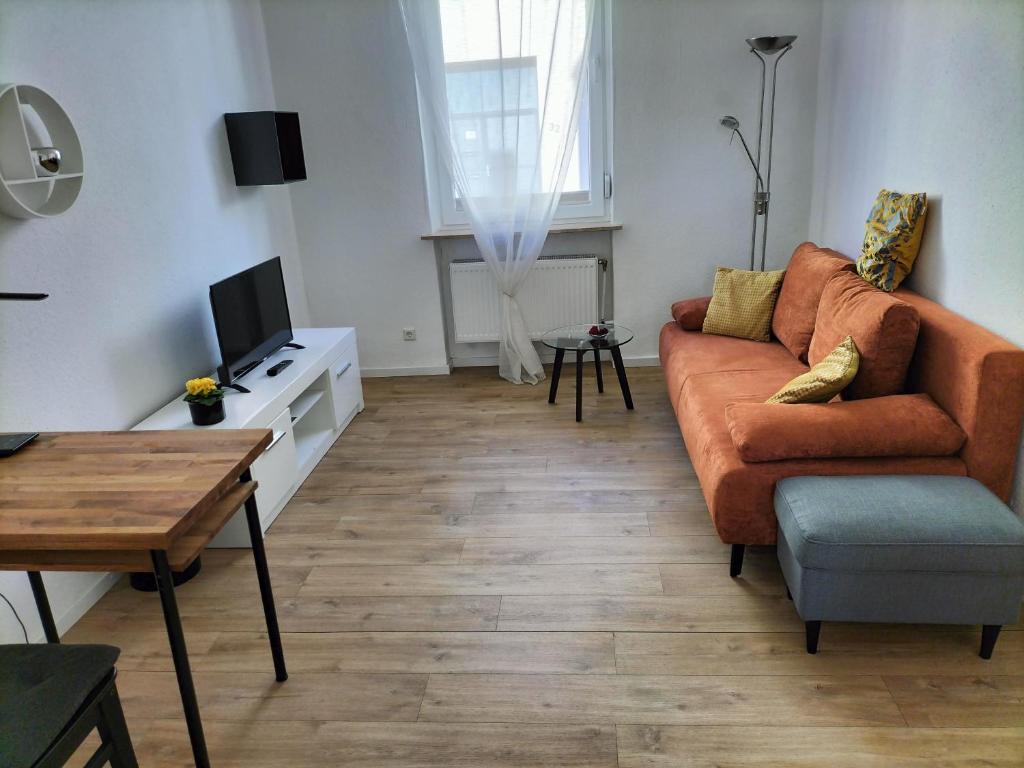 a living room with a couch and a table at Falkennest-lu in Ludwigshafen am Rhein