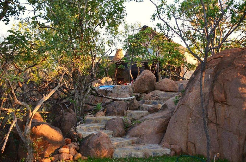 a set of stone stairs in a garden with trees at Kukama's Rest at Zebula 317 in Mabula