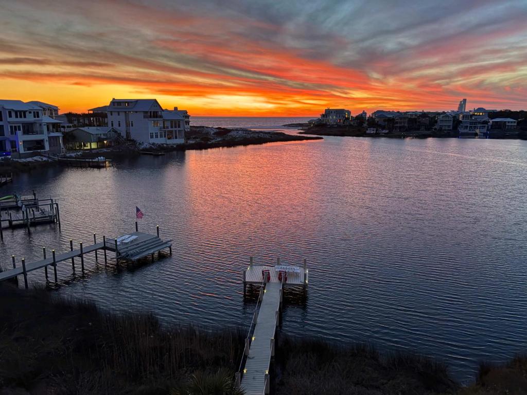 a dock on a body of water with a sunset at 283 Lakeview Drive in Seagrove Beach