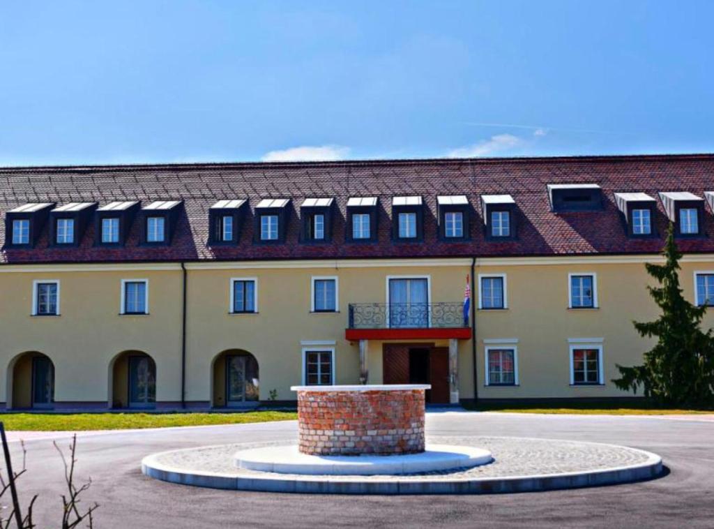 a large building with a fountain in front of it at Jurjevec Castle in Brežane Lekeničke