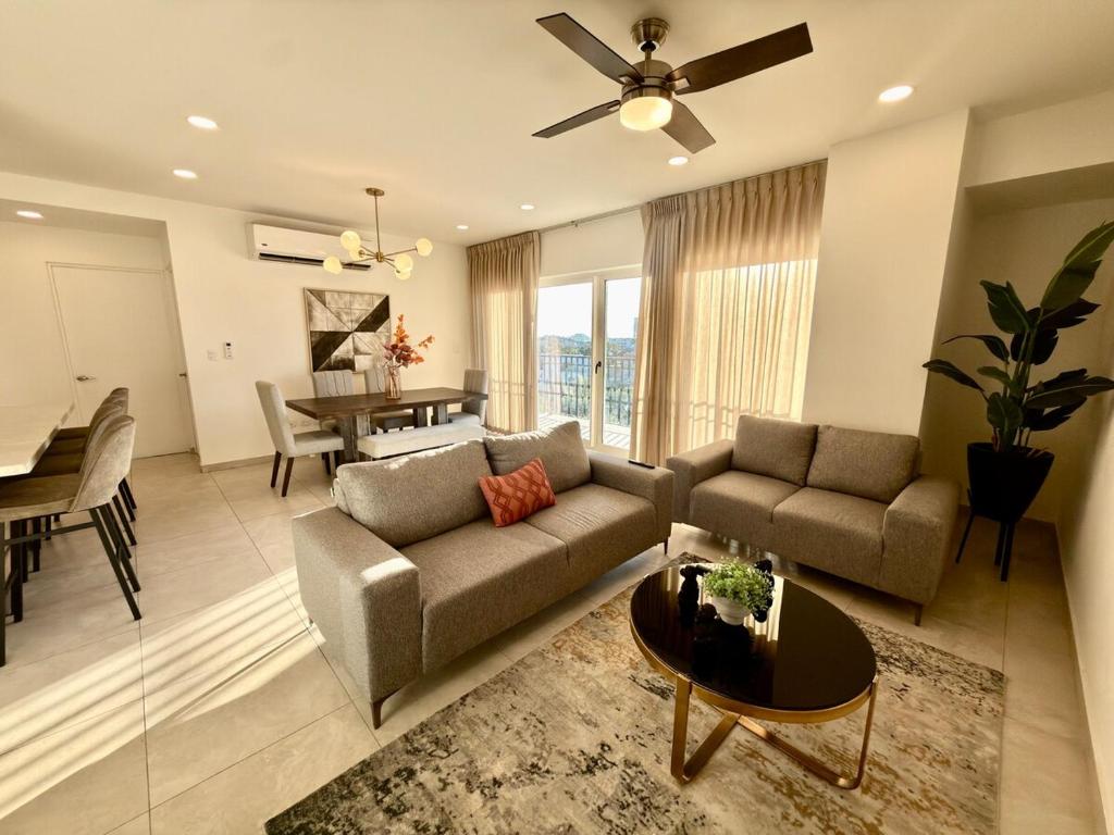 a living room with a couch and a table at Spacious Central Apartment, Pool & Gym, Group Friendly in Hermosillo