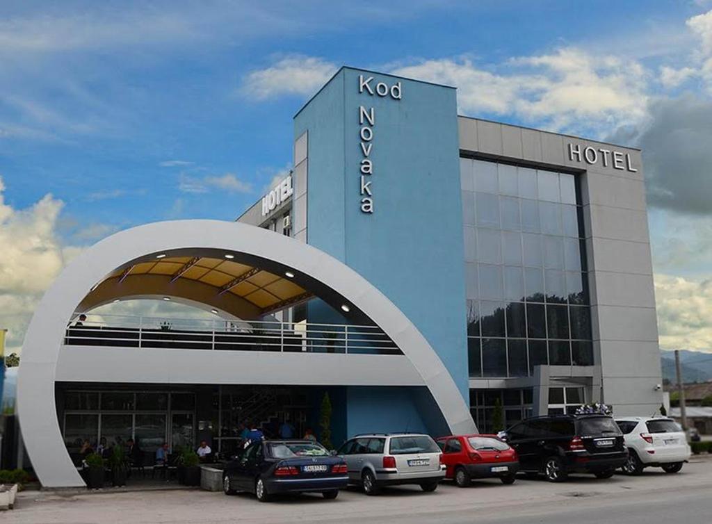 a hotel with cars parked in front of it at Hotel Novak in Zvornik