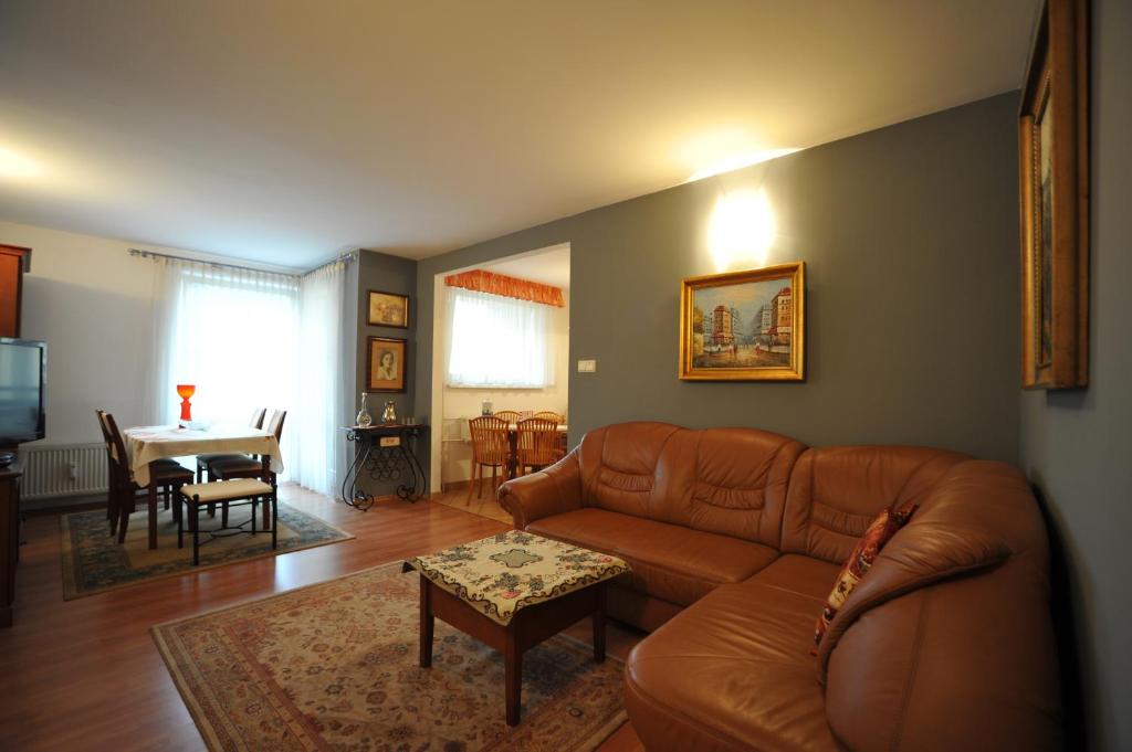 a living room with a couch and a table at Apartament Tais in Wrocław