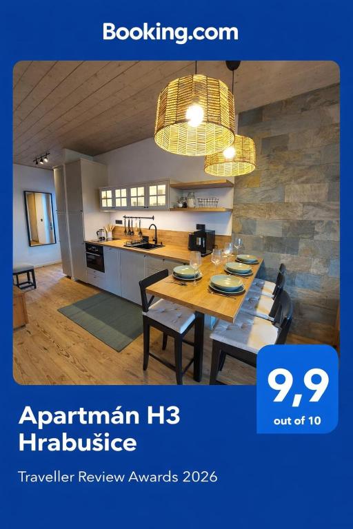 a kitchen and a dining room with a table and chairs at Apartmán H3 Hrabušice in Hrabušice