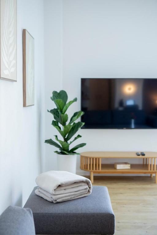 a living room with a couch and a table at PuraStays - studio 2 in Herzogenaurach