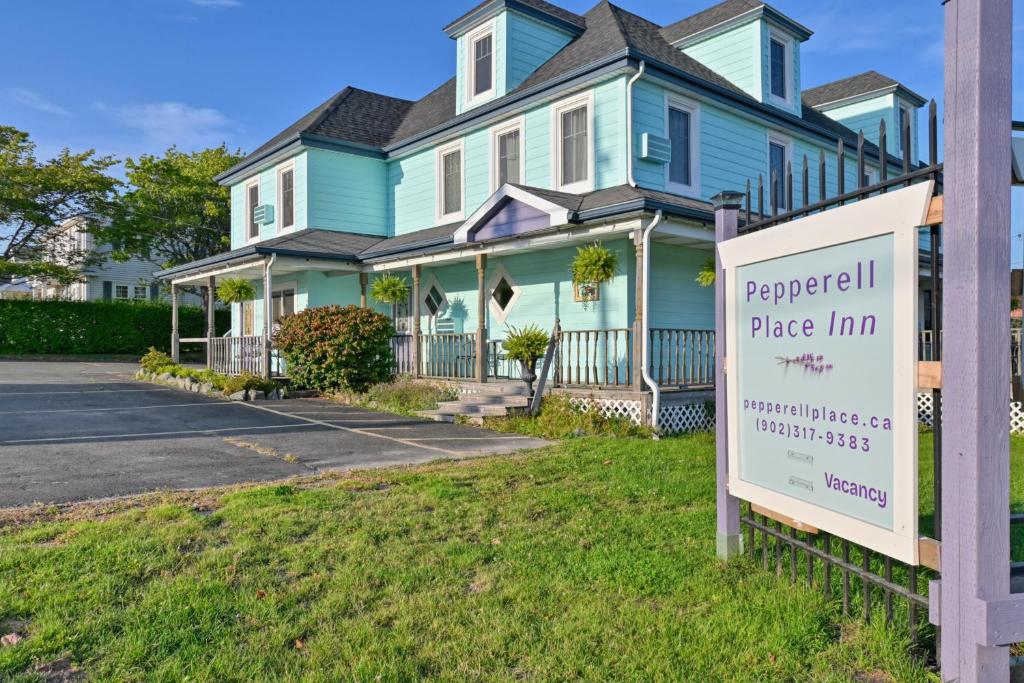 a house with a sign in front of it at Pepperell Place Inn Inc. in St. Peter's
