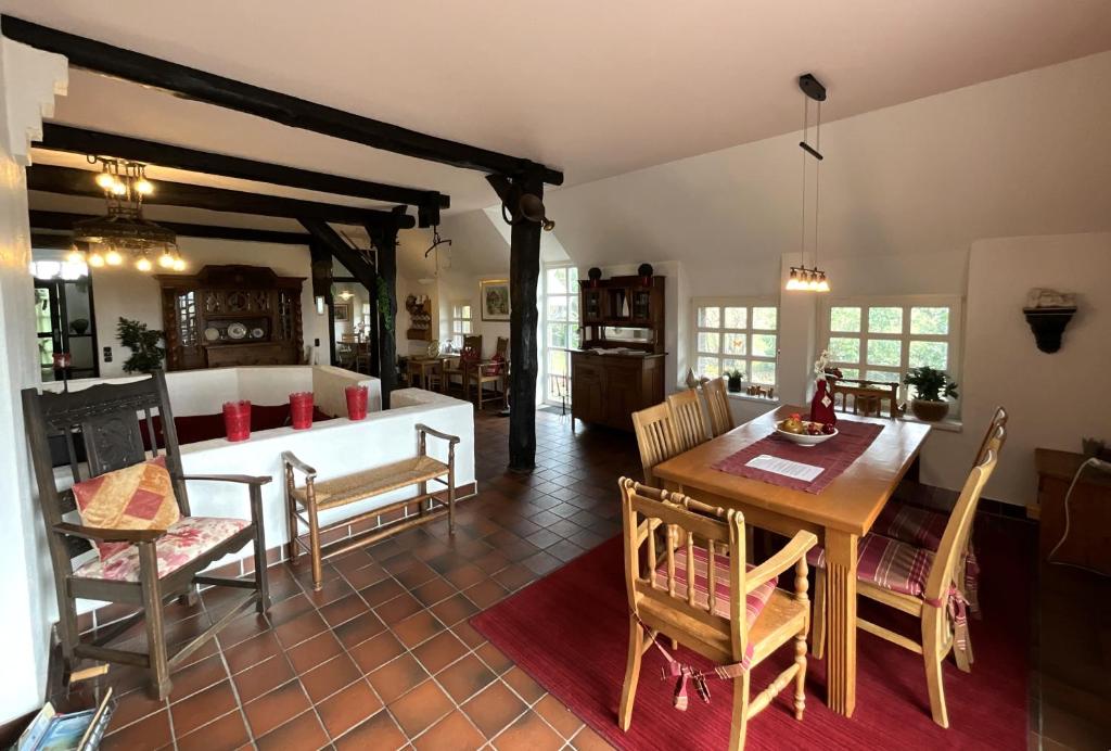a dining room and living room with a table and chairs at Haus Birkenhof in Moorhausen