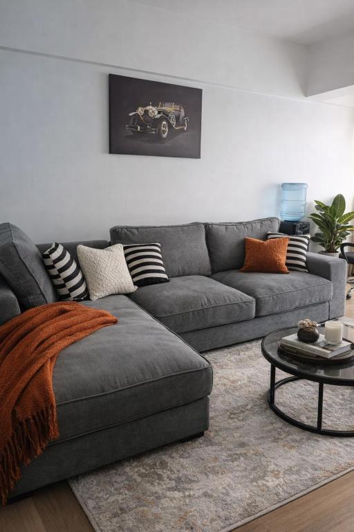 a living room with a gray couch and a table at Starla one bedroom duplex in Kinoo