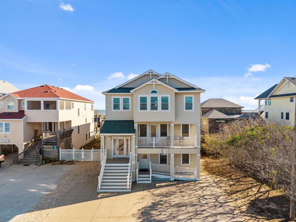 a large house with stairs leading up to it at Atlantic Watch in Kill Devil Hills